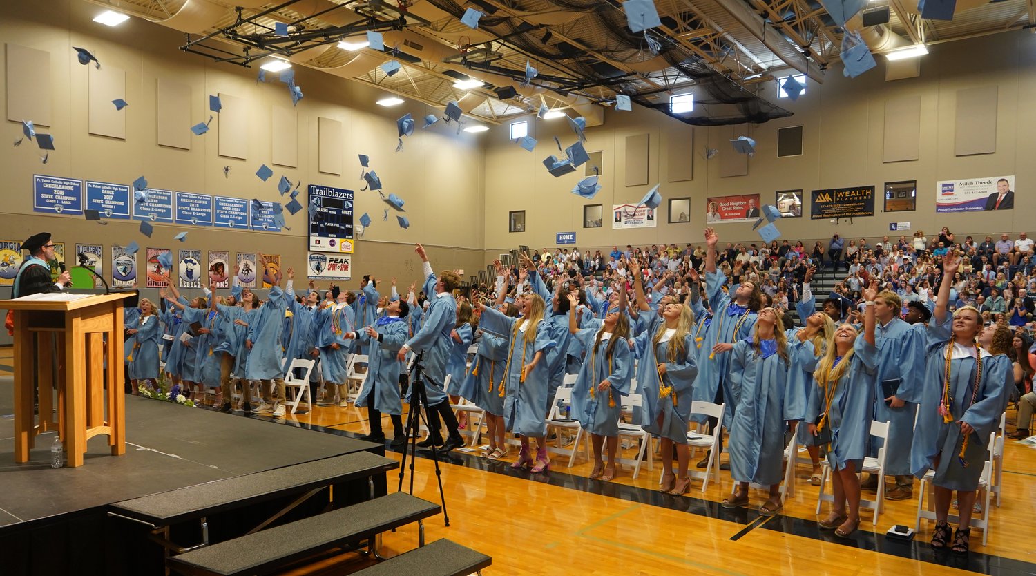 The members of Fr. Tolton Regional Catholic High School’s Class of 2022 toss their mortarboards into the air at the end of their graduation ceremony on May 15 in Columbia.